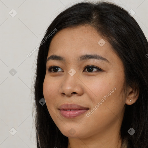 Joyful asian young-adult female with long  brown hair and brown eyes