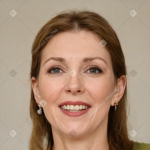 Joyful white adult female with medium  brown hair and green eyes