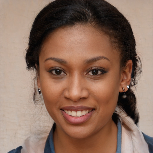 Joyful black young-adult female with medium  brown hair and brown eyes