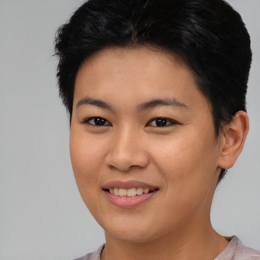 Joyful asian young-adult female with short  black hair and brown eyes