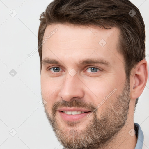 Joyful white young-adult male with short  brown hair and brown eyes