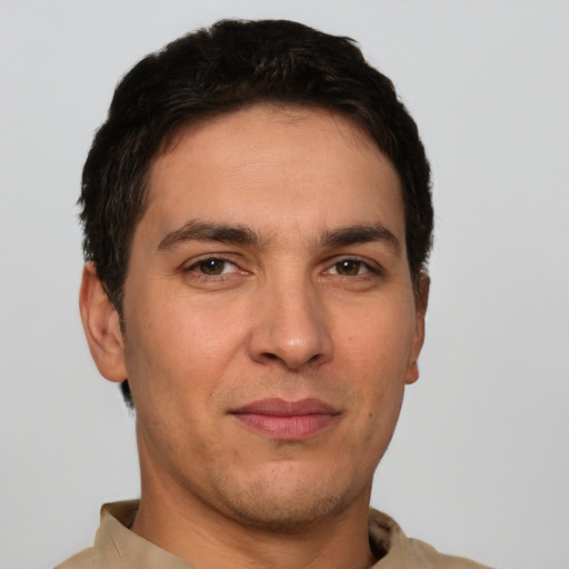 Joyful white young-adult male with short  brown hair and brown eyes