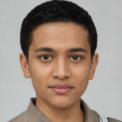 Joyful latino young-adult male with short  brown hair and brown eyes