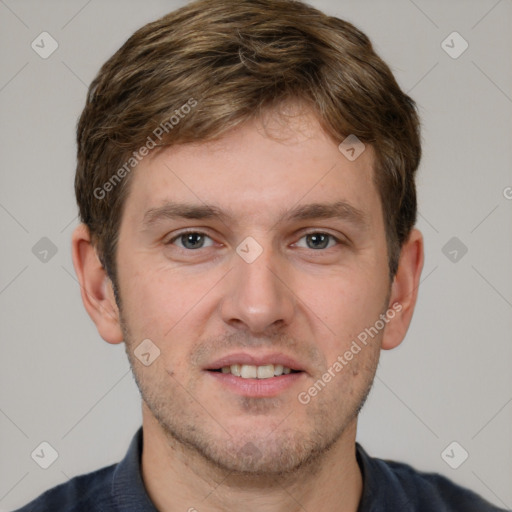 Joyful white young-adult male with short  brown hair and grey eyes