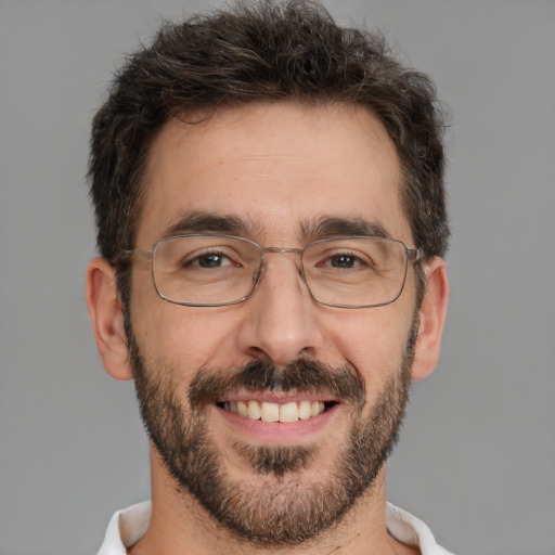 Joyful white adult male with short  brown hair and brown eyes