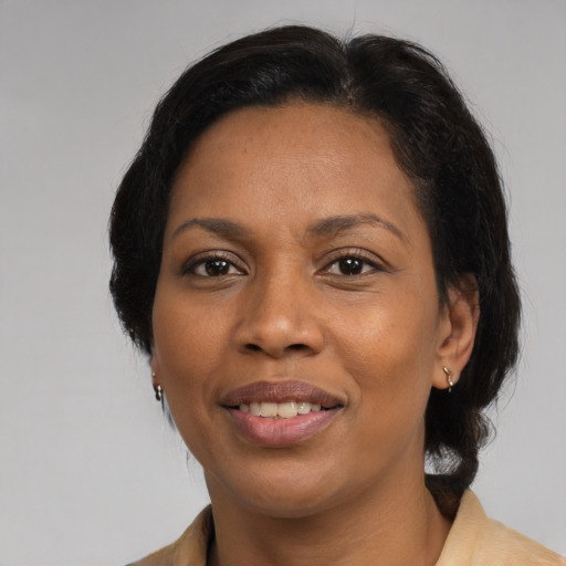 Joyful black adult female with medium  black hair and brown eyes