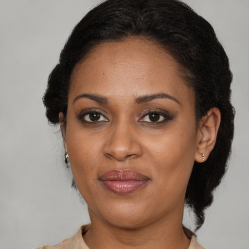 Joyful black adult female with short  brown hair and brown eyes