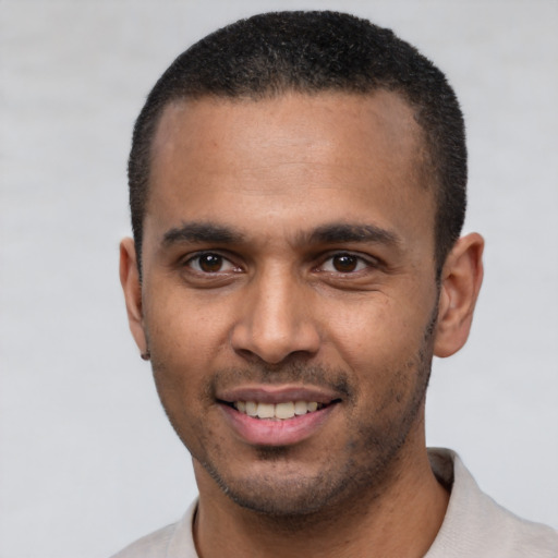 Joyful latino young-adult male with short  black hair and brown eyes