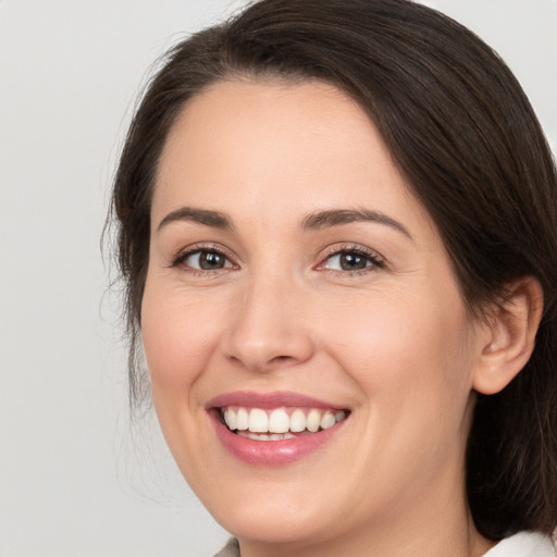 Joyful white young-adult female with medium  brown hair and brown eyes