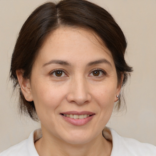 Joyful white adult female with medium  brown hair and brown eyes