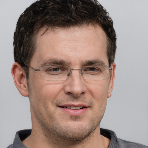 Joyful white adult male with short  brown hair and brown eyes