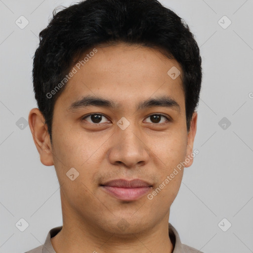 Joyful latino young-adult male with short  brown hair and brown eyes