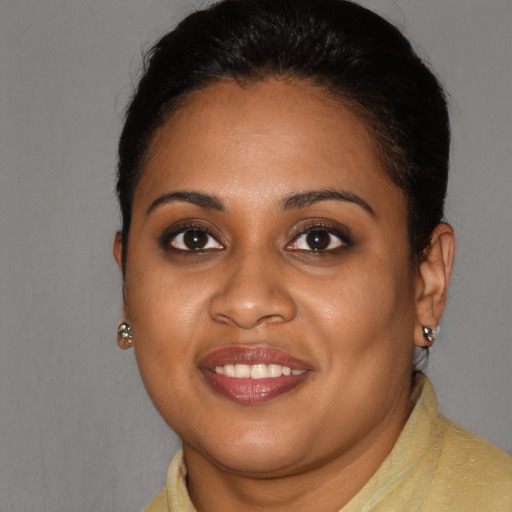 Joyful black young-adult female with short  brown hair and brown eyes