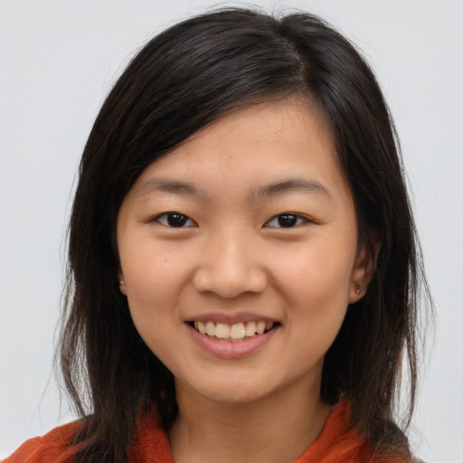 Joyful asian young-adult female with long  brown hair and brown eyes
