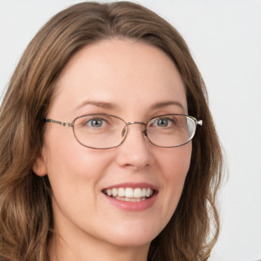 Joyful white young-adult female with long  brown hair and green eyes