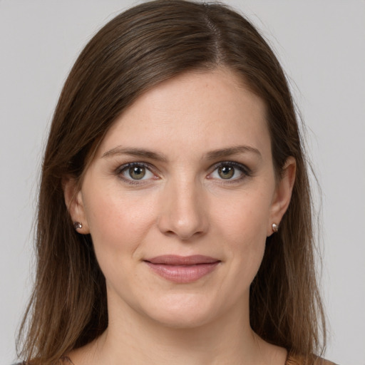 Joyful white young-adult female with medium  brown hair and grey eyes