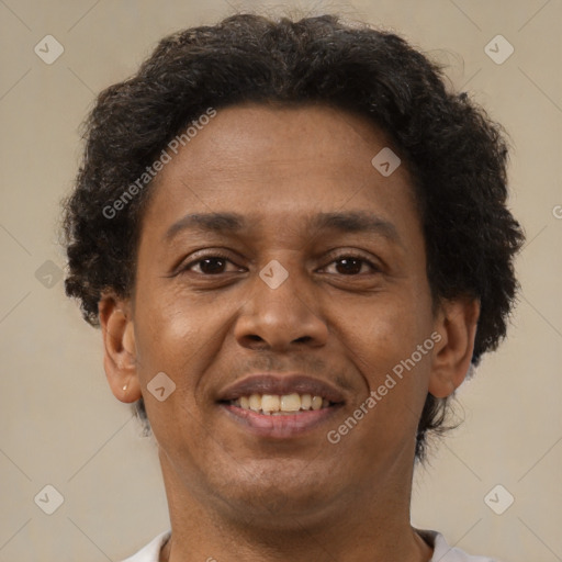 Joyful latino adult male with short  brown hair and brown eyes