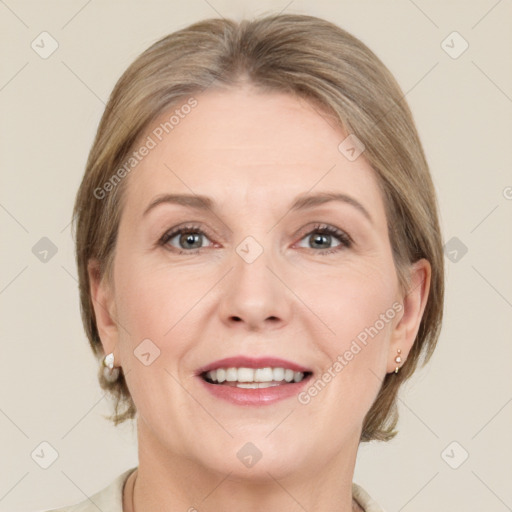 Joyful white adult female with medium  brown hair and grey eyes