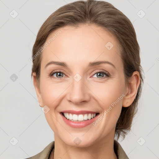 Joyful white young-adult female with medium  brown hair and grey eyes