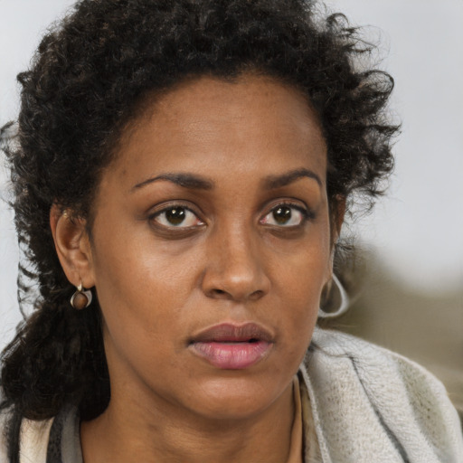 Neutral black adult female with medium  brown hair and brown eyes