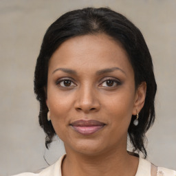 Joyful black young-adult female with medium  brown hair and brown eyes