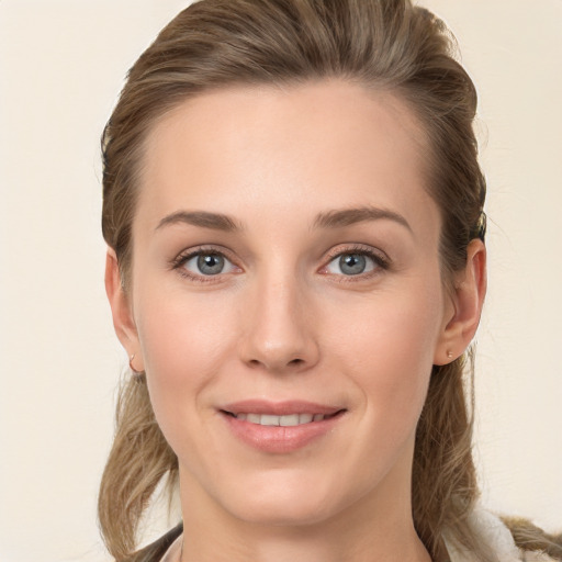 Joyful white young-adult female with long  brown hair and grey eyes