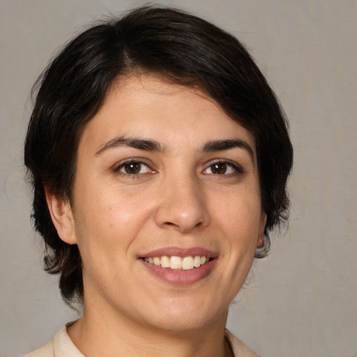 Joyful white young-adult female with medium  brown hair and brown eyes