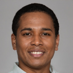 Joyful latino young-adult male with short  brown hair and brown eyes