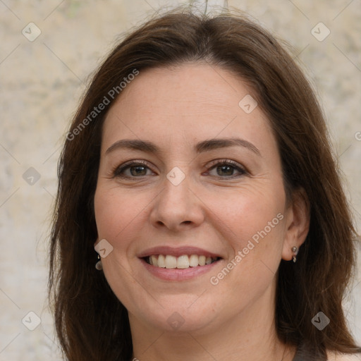 Joyful white adult female with long  brown hair and brown eyes