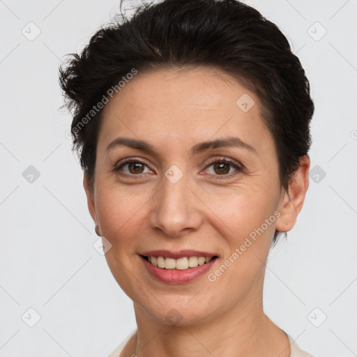 Joyful white adult female with short  brown hair and brown eyes