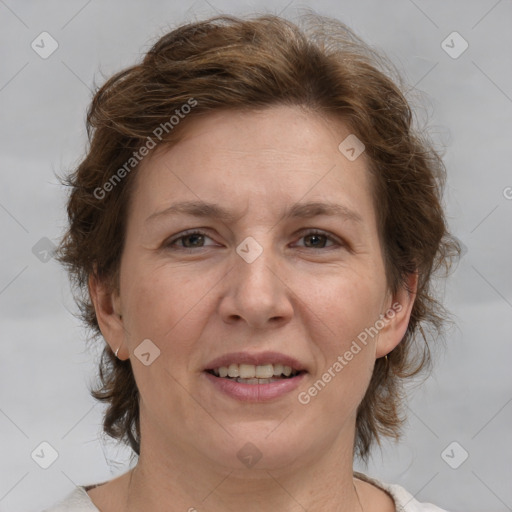 Joyful white adult female with medium  brown hair and grey eyes