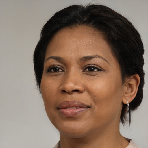 Joyful black adult female with medium  brown hair and brown eyes