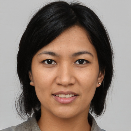 Joyful asian young-adult female with medium  black hair and brown eyes