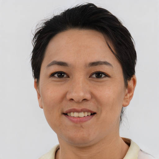 Joyful asian adult female with short  brown hair and brown eyes