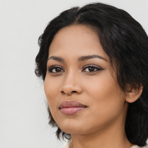 Joyful latino young-adult female with medium  black hair and brown eyes