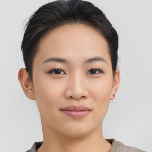 Joyful asian young-adult female with short  brown hair and brown eyes