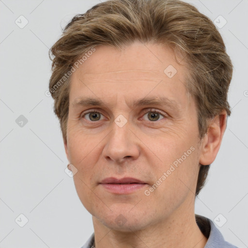 Joyful white adult male with short  brown hair and grey eyes