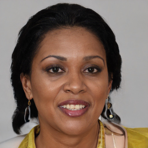 Joyful black adult female with medium  brown hair and brown eyes