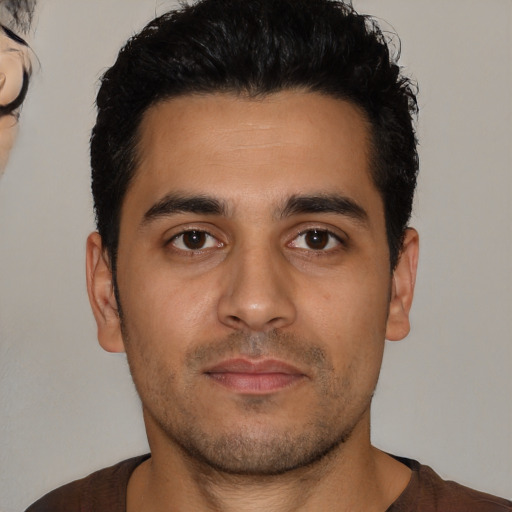 Neutral latino young-adult male with short  brown hair and brown eyes