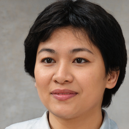 Joyful white young-adult female with medium  black hair and brown eyes