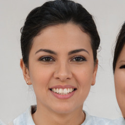 Joyful asian young-adult female with medium  brown hair and brown eyes