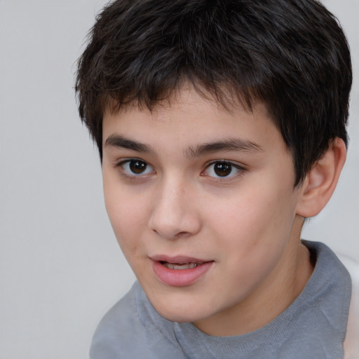 Joyful white child male with short  brown hair and brown eyes