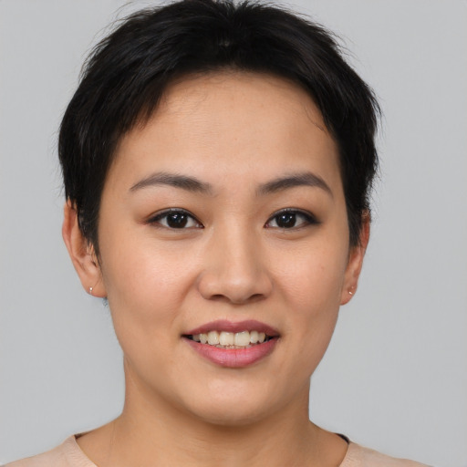 Joyful asian young-adult female with short  brown hair and brown eyes