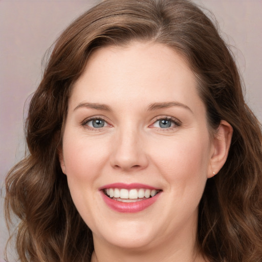 Joyful white young-adult female with long  brown hair and green eyes