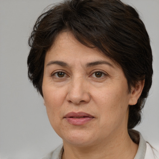 Joyful white adult female with medium  brown hair and brown eyes