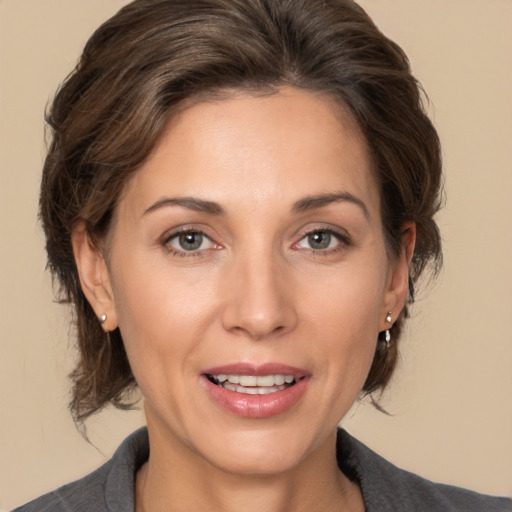 Joyful white adult female with medium  brown hair and brown eyes