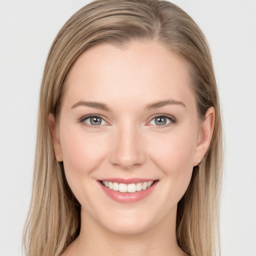 Joyful white young-adult female with long  brown hair and grey eyes