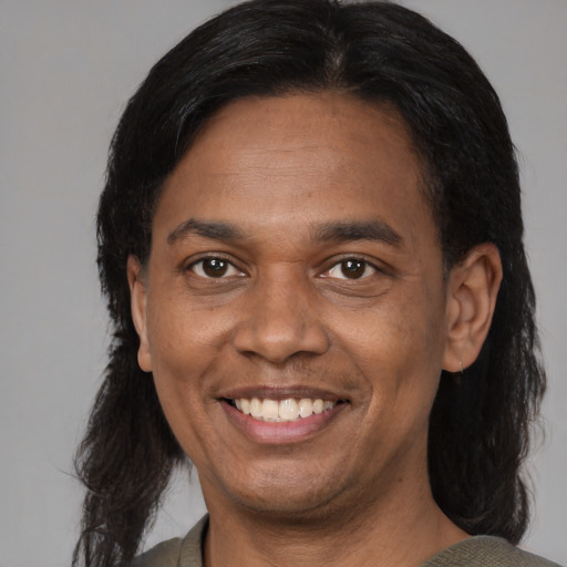 Joyful latino adult male with medium  black hair and brown eyes