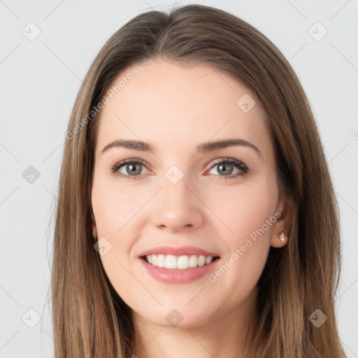 Joyful white young-adult female with long  brown hair and grey eyes