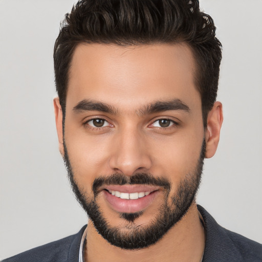 Joyful white young-adult male with short  black hair and brown eyes